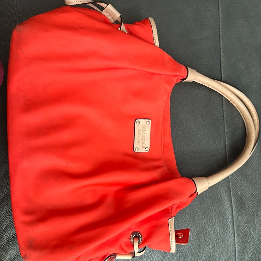 Kate Spade bag; scarlet orange nylon with beige leather handles.